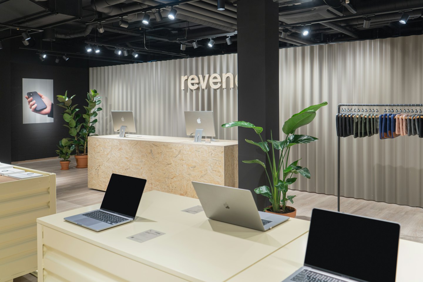 Modern showroom with laptops, desktop computers, and accessories.